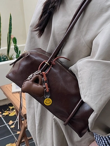 Retro dark brown oily leather shoulder bag with vintage charms and yellow smiley face