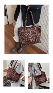 Detail of leopard print tote bag with cute animal embroidery patch and canvas texture