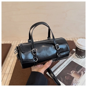 Detail showing the glossy black surface and silver hardware of the Boston bowling bag