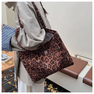 Detail shot of leopard print tote bag with bear embroidery and wide shoulder strap