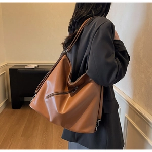 Brown leather large capacity tote bag shown from back view with adjustable straps