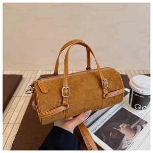 Detail showing brown suede texture and silver buckle strap on a vintage bowling bag