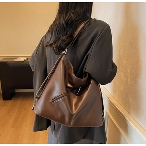 Detail shot of the vintage dark brown hobo bag with a side zipper pocket and soft texture