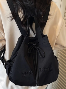 Minimalist black drawstring bucket backpack for women with Young Bear embroidery