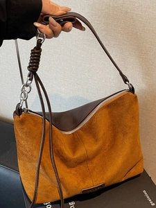 Brown suede tote bag with leather trim and decorative knotted strap details for women