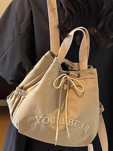 Korean style cream drawstring bucket backpack for women with embroidered YOU JI BEAR logo