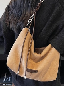 Minimalist tan leopard print tote bag with brown straps and silver chain details