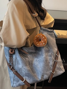 Vintage blue canvas tote bag with adjustable leather straps and donut plush pendant accessory