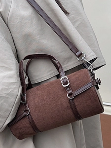 Brown bowling bag in matte suede with adjustable shoulder strap and silver hardware