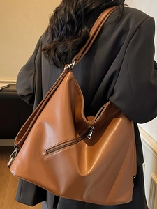 Vintage brown leather tote backpack for women showing back zipper and matte texture