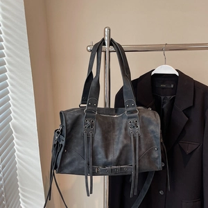 Detail view of charcoal grey vintage Boston bag with lace-up eyelets and adjustable strap