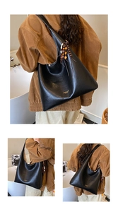 Detail shot of the black leather hobo bag featuring ethnic beaded tassels and fringe