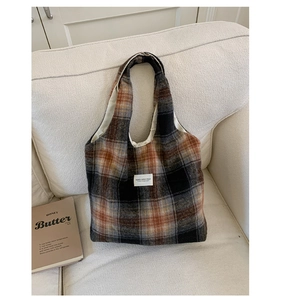 Close-up of vintage orange plaid wool tote bag showing texture and woven brand label