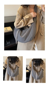 Detail of grey waffle textured crescent bag with stylish drawstring and wide shoulder strap