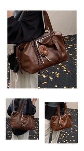 Macro view of dark brown tote bag details with donut pendant in an autumn setting