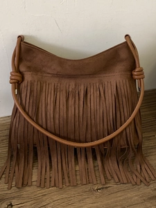 Brown suede shoulder bag with bohemian long tassels and vintage knotted strap design