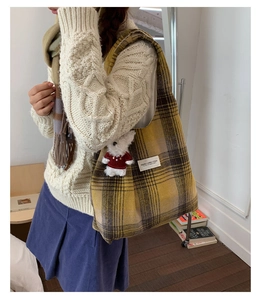 Detailed shot of yellow plaid wool tote bag with a cute white bear pendant charm