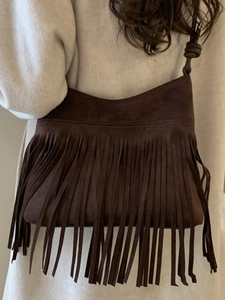 Minimalist bohemian dark brown suede crossbody bag with long fringe and knot detail strap
