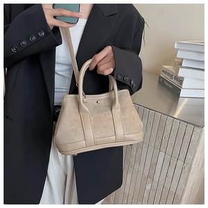 Detail of a beige suede-texture拼接 rectangular handbag with detachable slim shoulder strap
