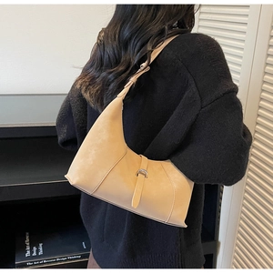 Chic beige suede crescent hobo bag with adjustable strap and silver metal buckle