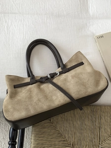 Minimalist beige suede tote bag with deep brown leather straps and silver buckle detail