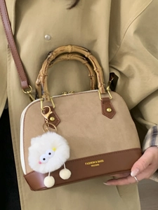 Retro shell tote with bamboo handle and plush charm in contrast beige and brown finish