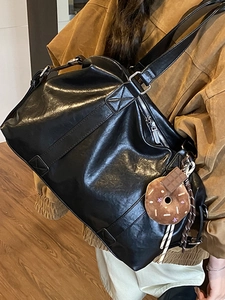 Large black glossy leather tote bag with cute donut charm for daily commute style