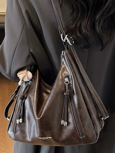 Vintage dark brown faux leather tote bag with tassel zippers and baseball charm detail