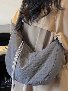 Minimalist grey waffle texture half-moon hobo bag with drawstring and shoulder strap