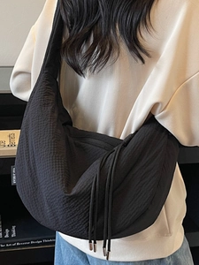 Minimalist black hobo crossbody bag with pleated texture and drawstring design