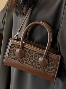 Fashionable leopard print crossbody bag with brown leather accents and top handle