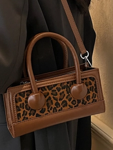 Fashionable leopard print rectangular handbag with brown leather trim and top handle strap