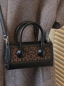 Retro leopard print mini crossbody bag with black leather trim and double round handles