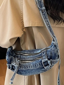 Vintage washed denim crossbody crescent bag with embroidery and adjustable metal eyelets