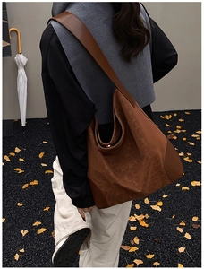 Detail view of leopard print tote bag with wide leather strap in a classic autumn setting
