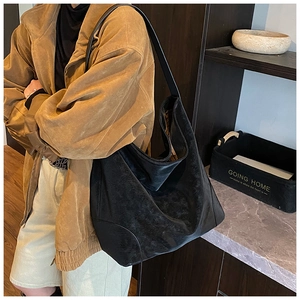 Detail shot of the large black tote bag featuring soft matte texture and durable strap