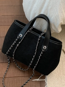 Large black suede tote bag with leather handles and chain straps for dual shoulder and hand carry