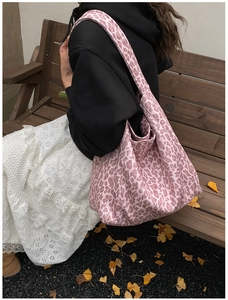 Pink leopard print canvas tote bag showcased on a park bench with autumn leaves
