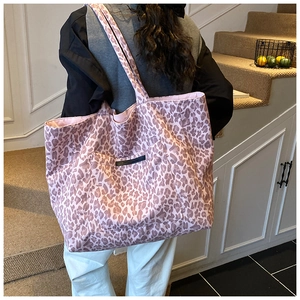 Pink leopard print tote bag shown on shoulder in a lifestyle setting for daily use