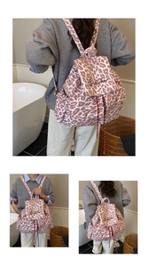 Detail view of pink leopard print canvas backpack with drawstring and embroidery