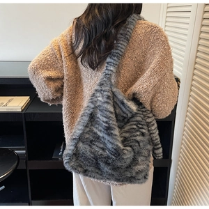 Close-up of fluffy striped faux fur tote bag showing soft texture and spacious design