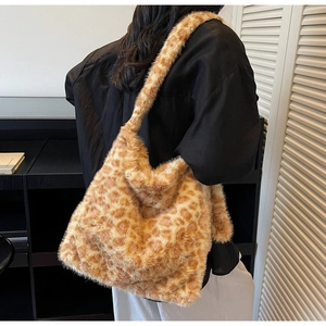 Macro detail of large leopard print faux fur tote bag showing plush texture on model