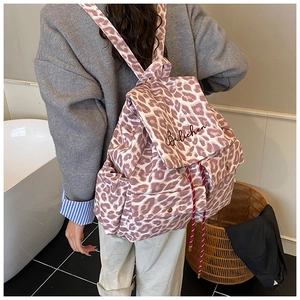 Detailed back view of leopard print canvas backpack with embroidery and drawstring closure
