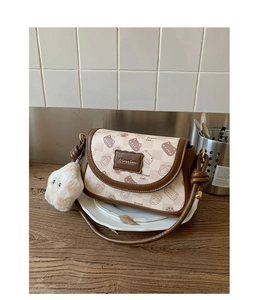 Detail of vintage square crossbody bag with bread cat print and cute plush charm