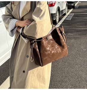 Outdoor shot of a vintage brown tote bag with high capacity and matte texture finish
