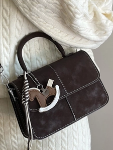 Retro dark brown crossbody bag with contrast stitching and horse pendant detail