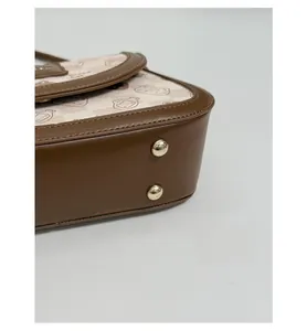 Close-up of bag bottom featuring gold metal studs and cute Bread Cat cartoon print