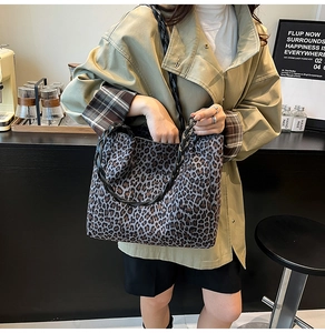 Close-up of leopard print tote bag featuring black woven rope handles and large capacity