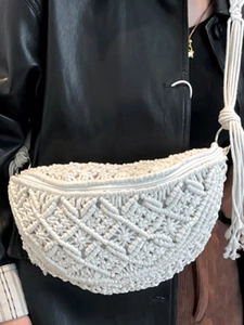 White woven crossbody beach bag with fringe and rope strap in bohemian style