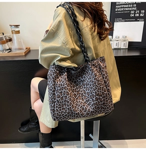 Detail of leopard print tote bag featuring rustic woven rope handles and fabric texture